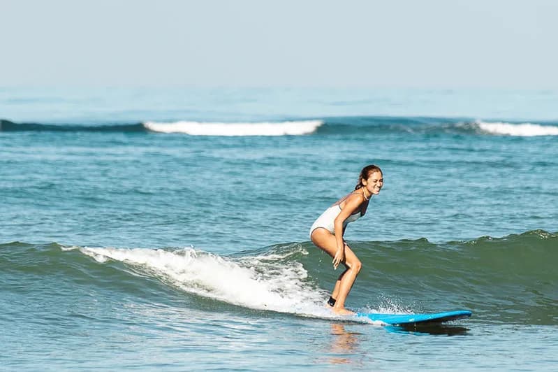 A surfer riding a wave off Urbiztondo Beach in San Juan, La Union.