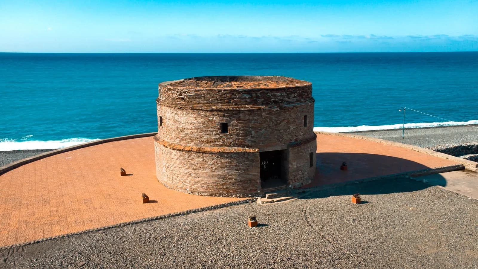 Aerial view of the Spanish-era Baluarte watchtower on Luna's pebble shore