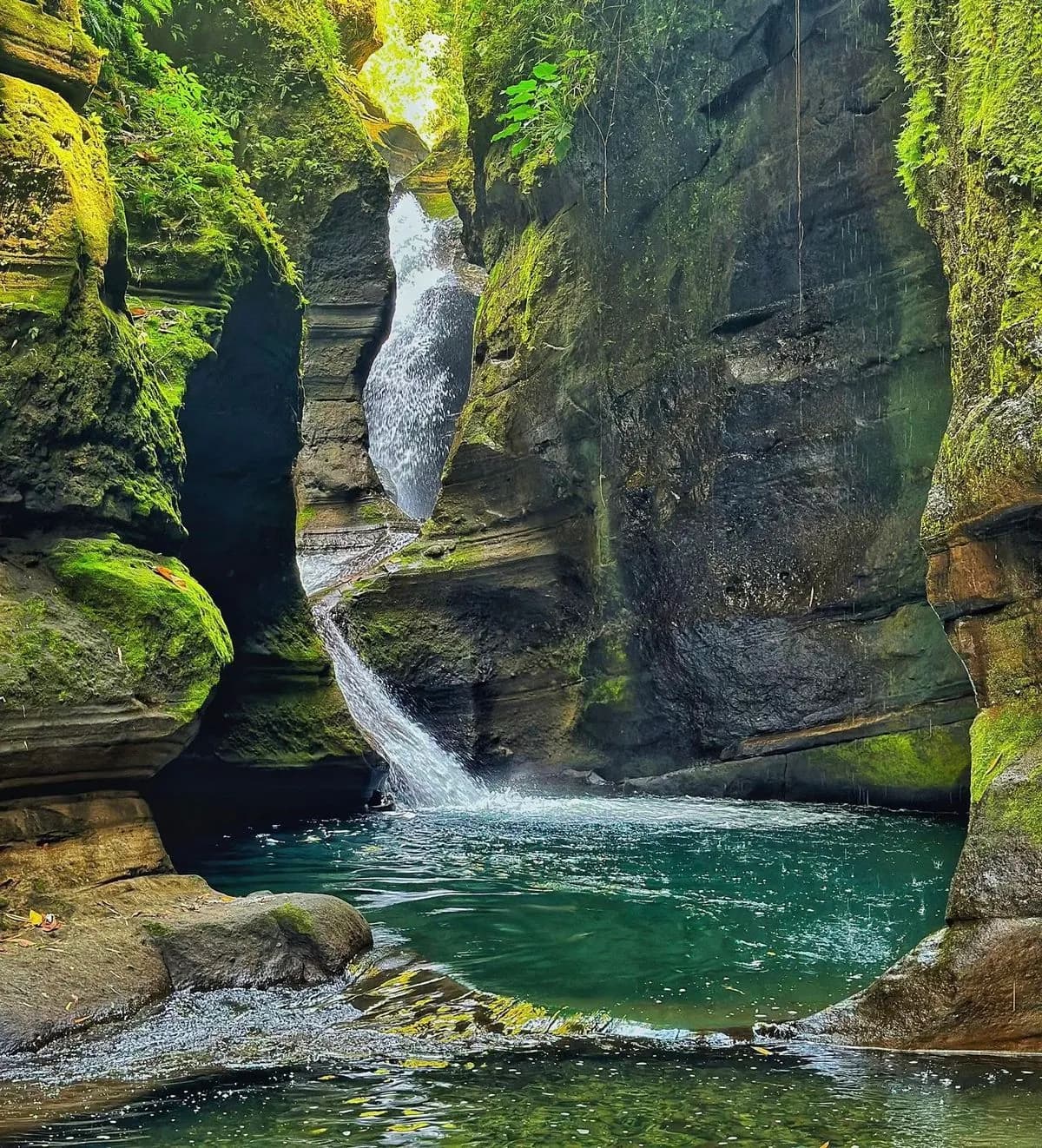 The turquoise rock pools and narrow cascade of Dupagan Falls in San Gabriel