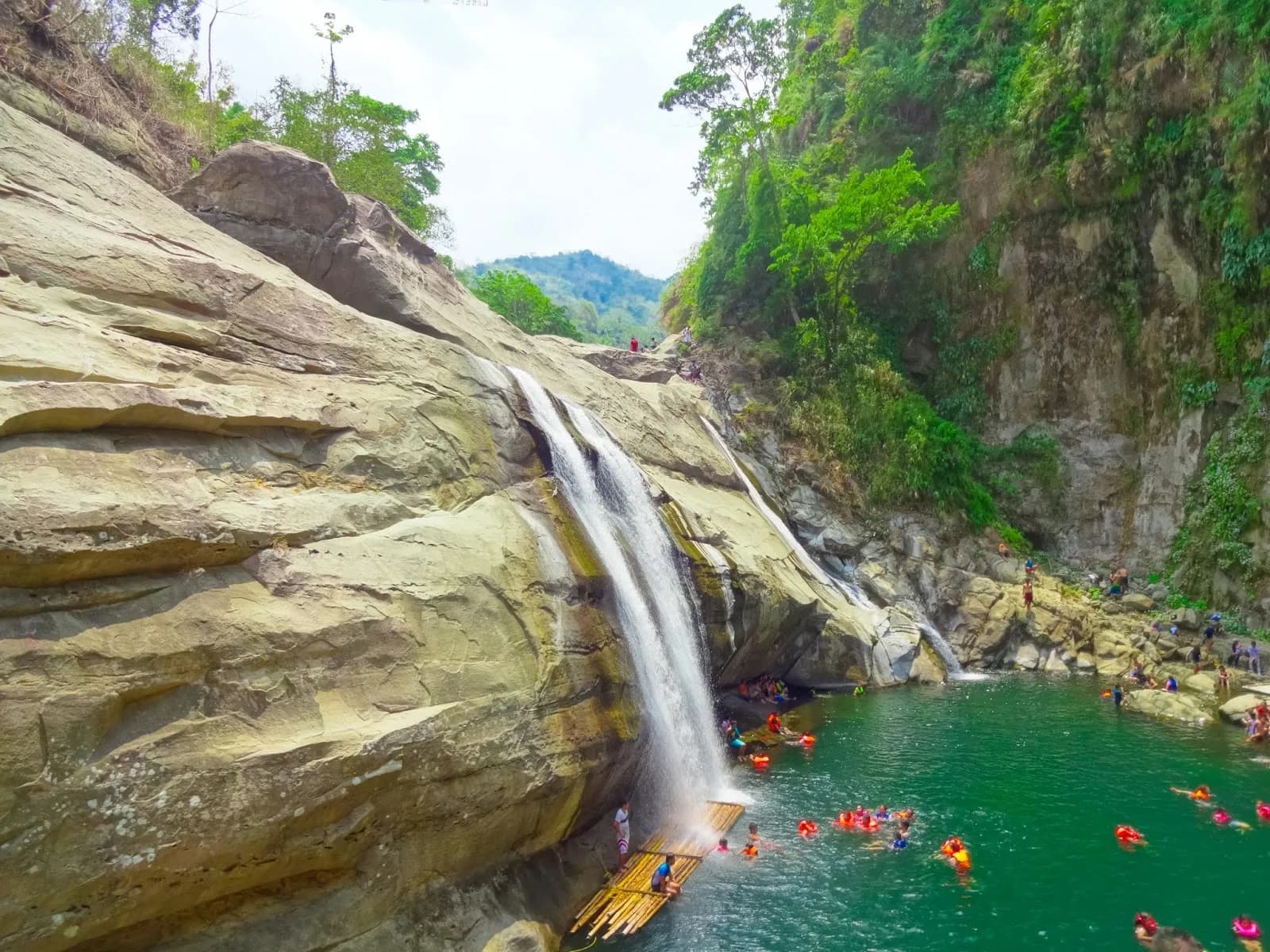 The wide sloping cascade of Tangadan Falls tumbling into its green pool in San Gabriel.