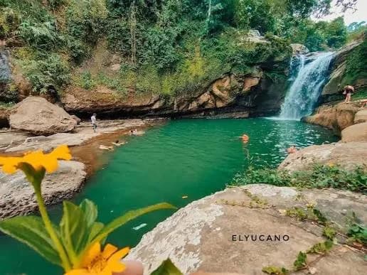 Balay Anito Falls flowing into a deep green swimming pool in Santol