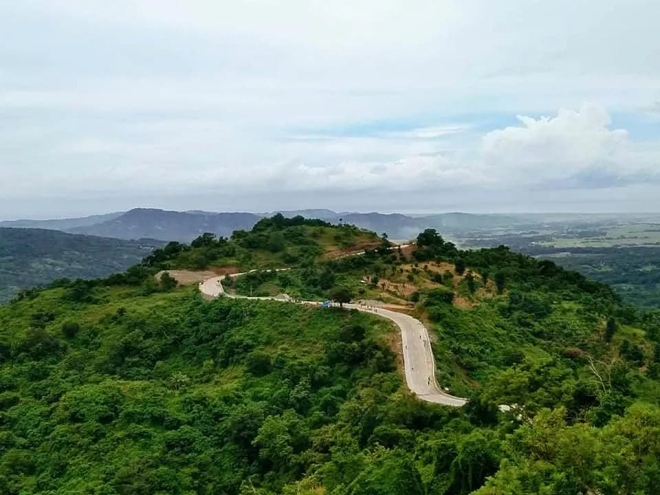 A winding road crossing the green mountain ridges of Sudipen