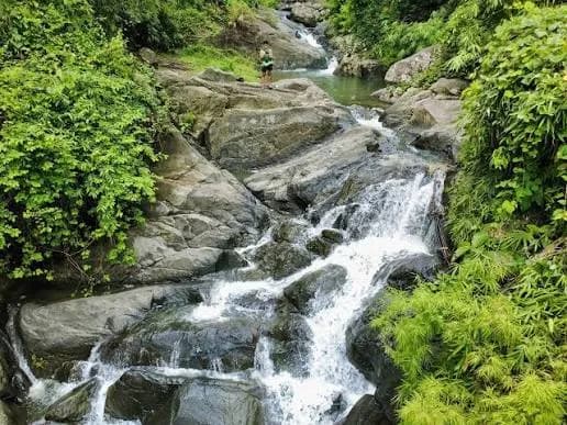 The sloping rock cascades and forest pools of Lang-ay Falls in Tubao